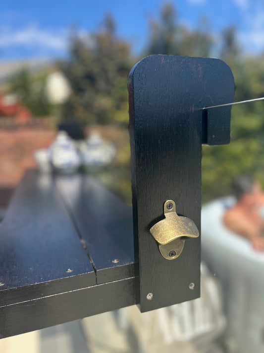 Brass bottle opener attached, outdoors.